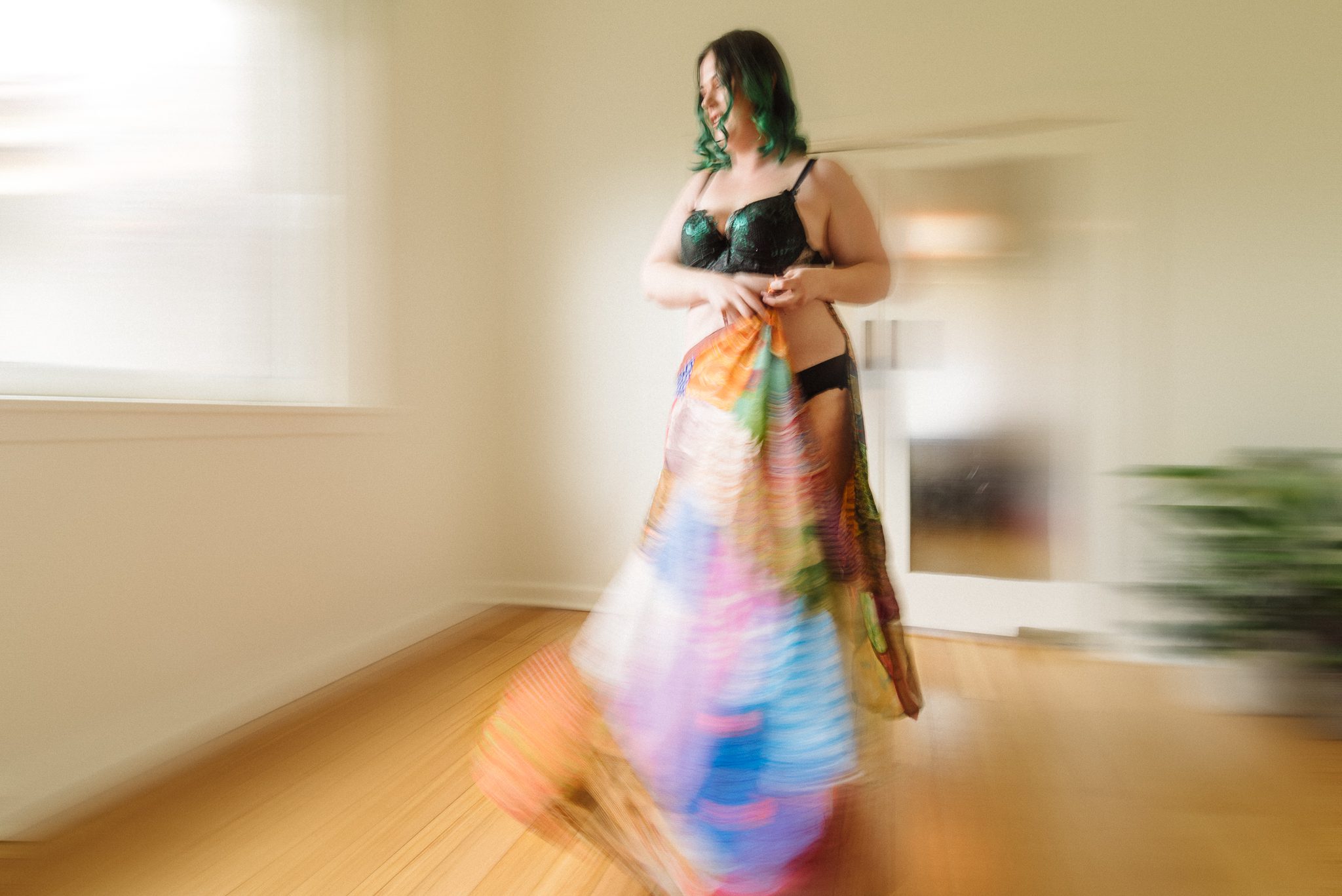 Motion blur photo of a woman and bright colourful skirt