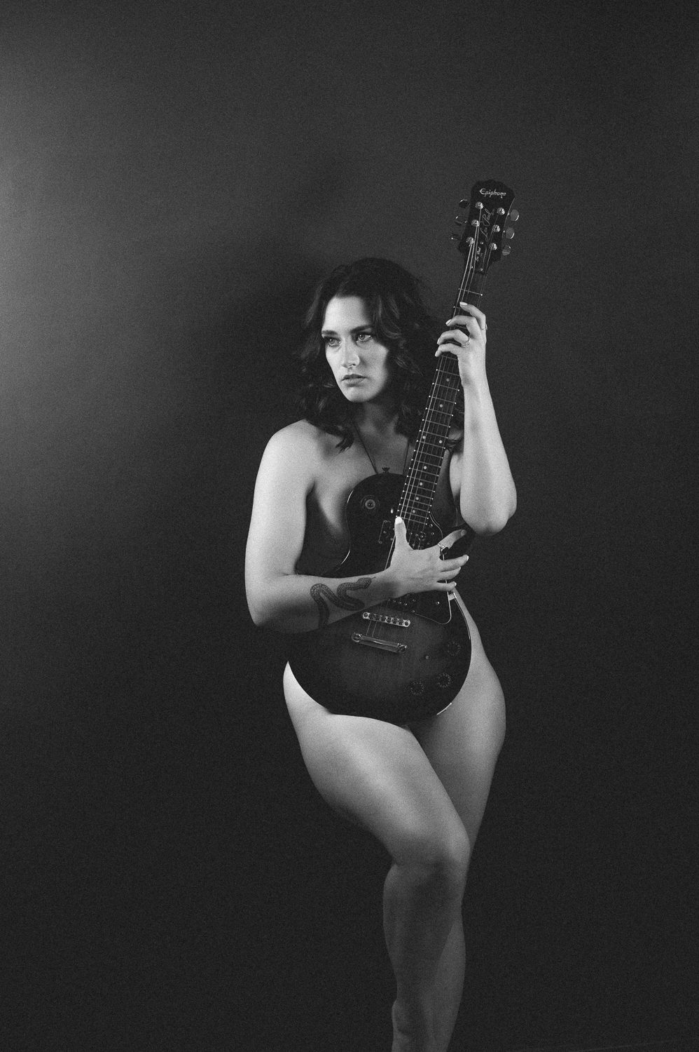 Use a guitar for implied topless photography.